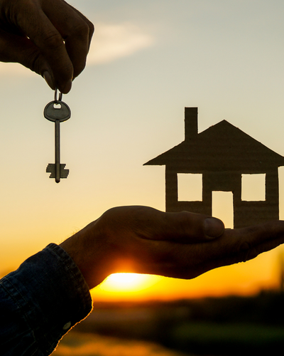 A key handoff at sunset, representing a successfully leased unit